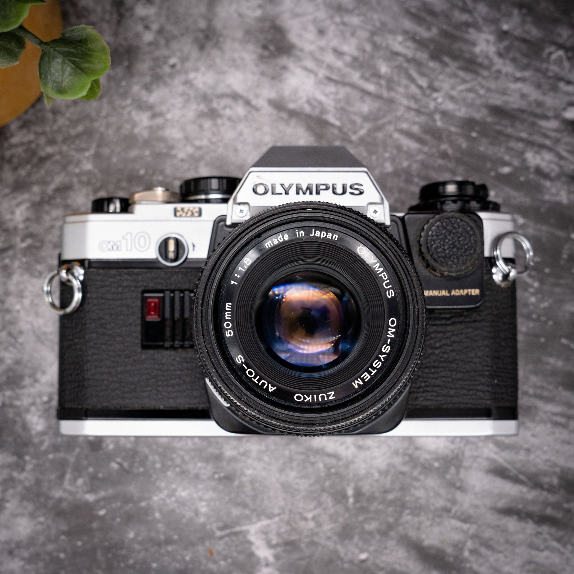 35mm Film Camera Kit | Olympus OM-10 + 50mm f/1.8 Lens, Manual Adapter, Roll Of Expired Film, Original Strap, Box & Instructions - Expired Film Club